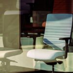 Image of office chairs showcasing lumbar support adjustments relevant to article topic.