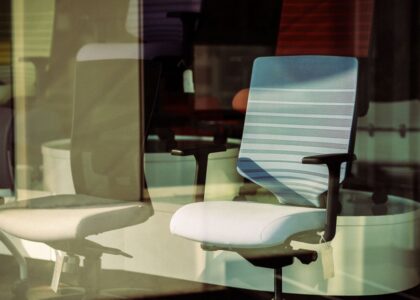 Image of office chairs showcasing lumbar support adjustments relevant to article topic.