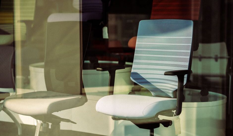 Image of office chairs showcasing lumbar support adjustments relevant to article topic.