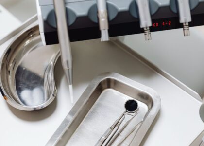 A dental mouth mirror and tools on a tray, illustrating cleaning methods.