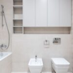 A modern bathroom with a bidet attachment and toilet, illustrating installation context.