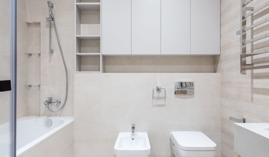 A modern bathroom with a bidet attachment and toilet, illustrating installation context.