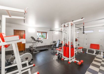 A home gym featuring a treadmill and various fitness equipment, relevant for replacing a treadmill belt.
