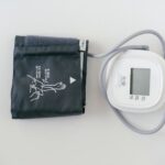 A digital blood pressure monitor and cuff, illustrating setup for measuring blood pressure.