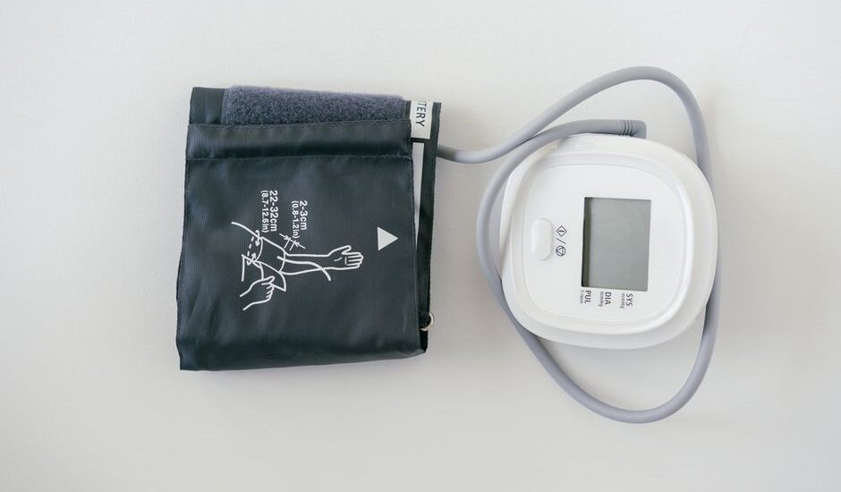 A digital blood pressure monitor and cuff, illustrating setup for measuring blood pressure.