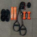 Resistance bands and workout equipment laid out on a gym floor.