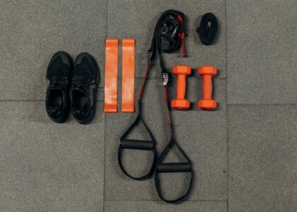 Resistance bands and workout equipment laid out on a gym floor.