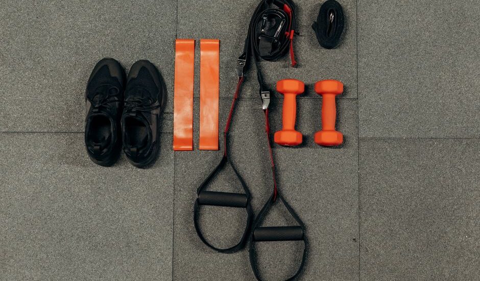 Resistance bands and workout equipment laid out on a gym floor.