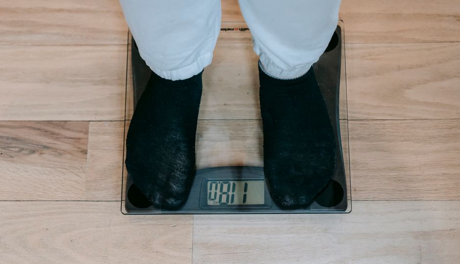 A person standing on a smart scale, relevant to the accuracy of smart scales.