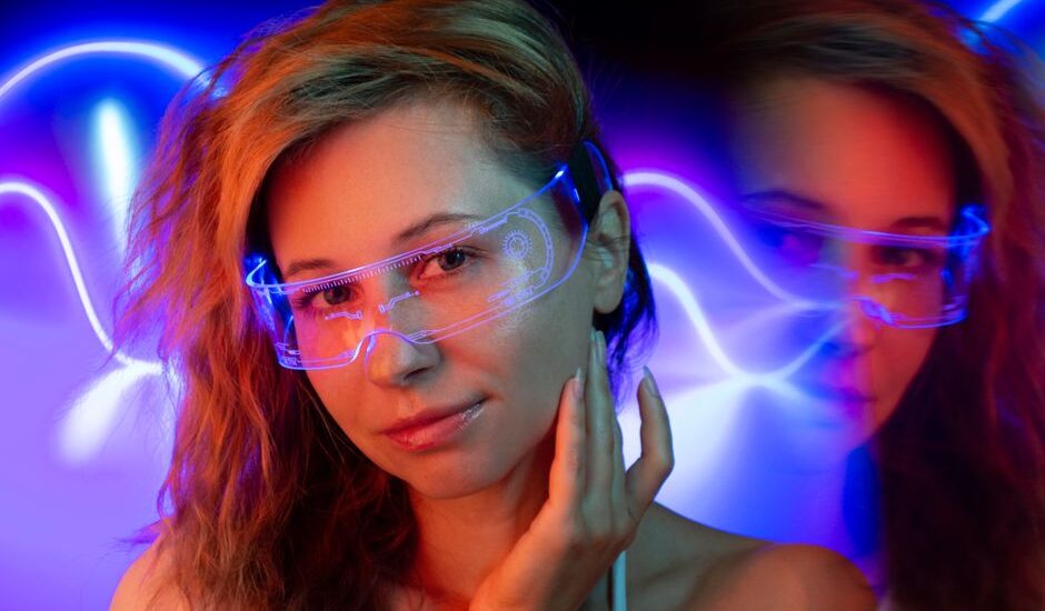 A woman wearing light therapy glasses designed to improve sleep, with colorful lights in the background.