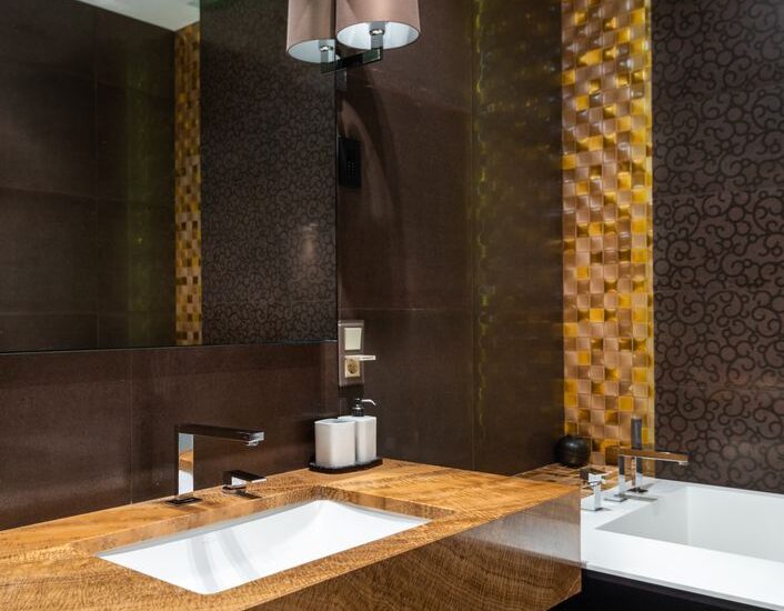 A stylish bathroom with a countertop and a visible automatic toothpaste dispenser.