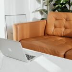 A workspace featuring a laptop on a marble table, highlighting the importance of adjustable footrests for comfort.