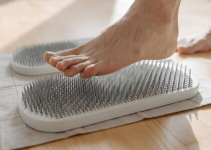 A foot stepping on a textured circulation booster, related to foot health.