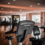 Image showing an upright bike and a recumbent bike in a gym, illustrating differences between bike types.
