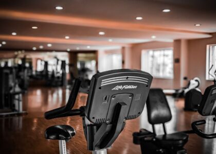 Image showing an upright bike and a recumbent bike in a gym, illustrating differences between bike types.