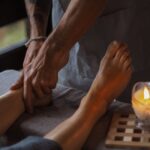 A person receiving a foot massage, illustrating techniques to boost foot circulation.