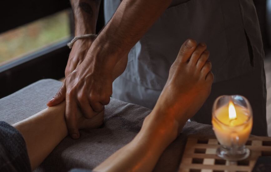 A person receiving a foot massage, illustrating techniques to boost foot circulation.