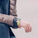 A person wearing a fitness tracker on their wrist, illustrating how to change the band.