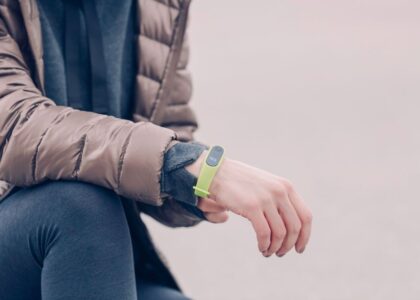 A person wearing a fitness tracker on their wrist, illustrating how to change the band.