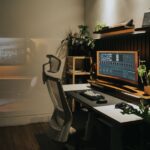 A modern home office featuring an ergonomic chair and a large monitor, relevant for orthopedic seat cushions.